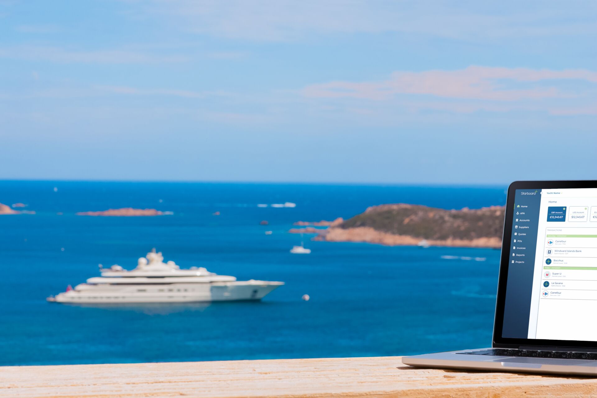 A superyacht cruising with a laptop shown in the image displaying the Starboard Card platform
